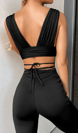 Open-back top and high-waisted bootcut trousers.