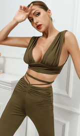 Open-back top and high-waisted bootcut trousers.